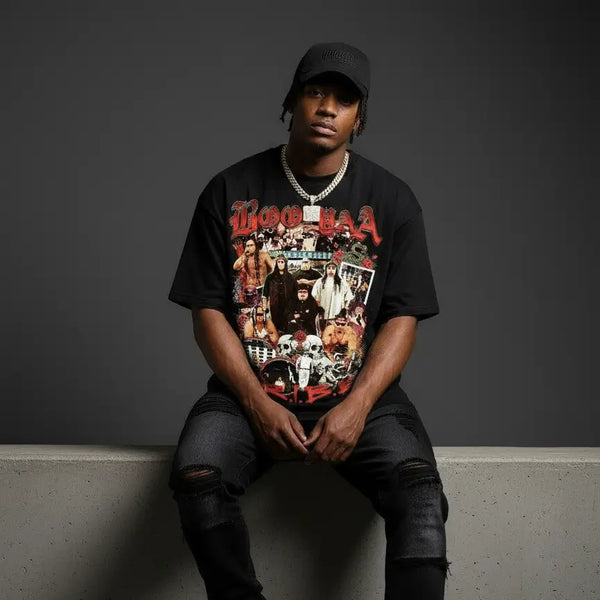 Person wearing a graphic t-shirt sitting on a concrete bench against a dark background
